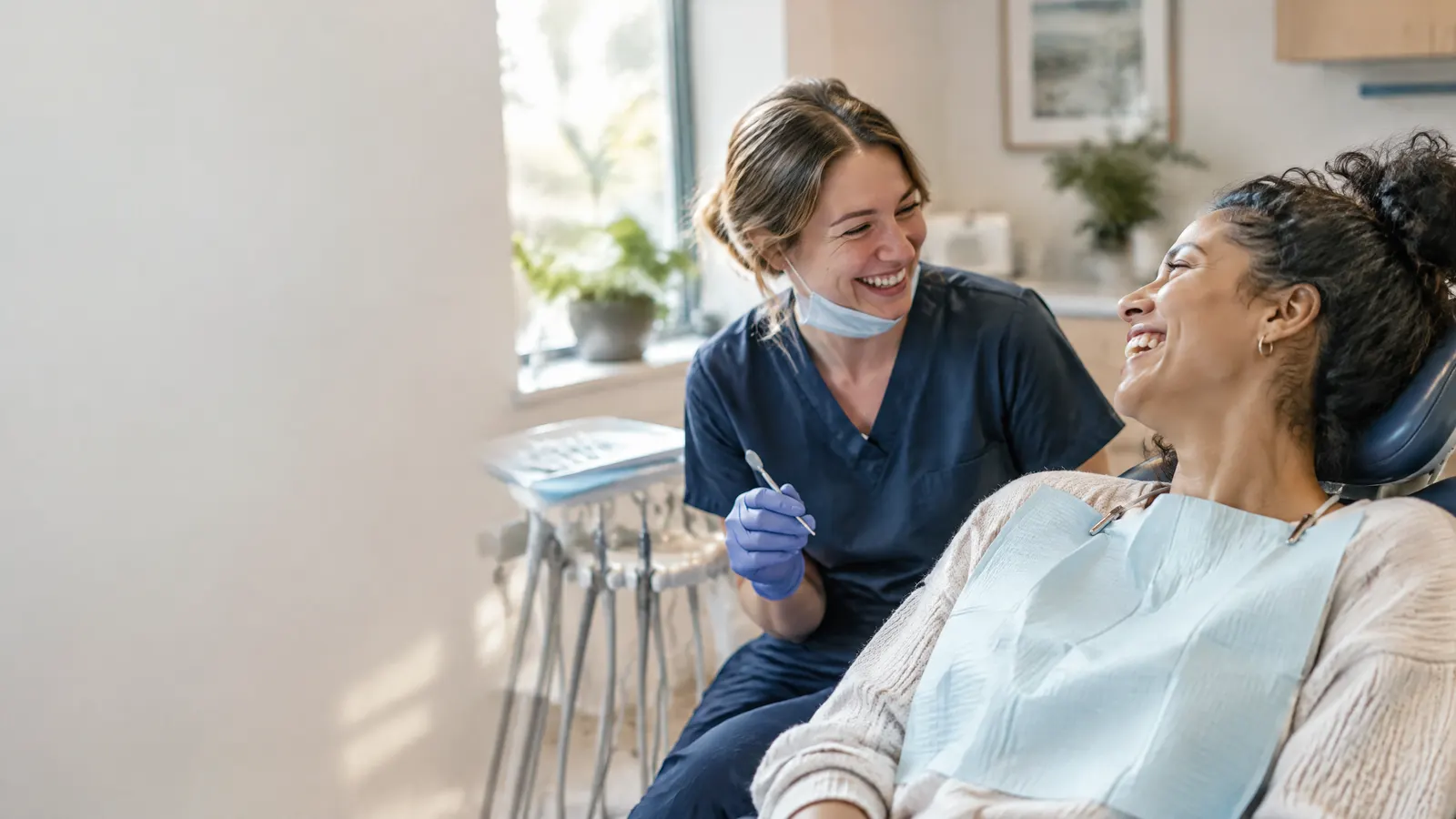 An early childhood educator at the dentist, laughing with the hygienist.