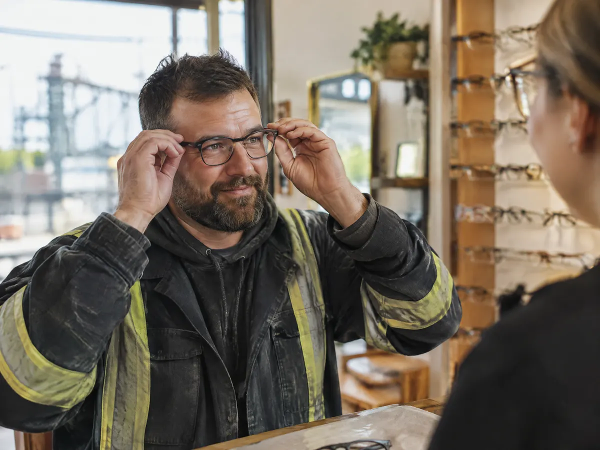 A Hamilton steelworker picking up new glasses at an optical shop.
