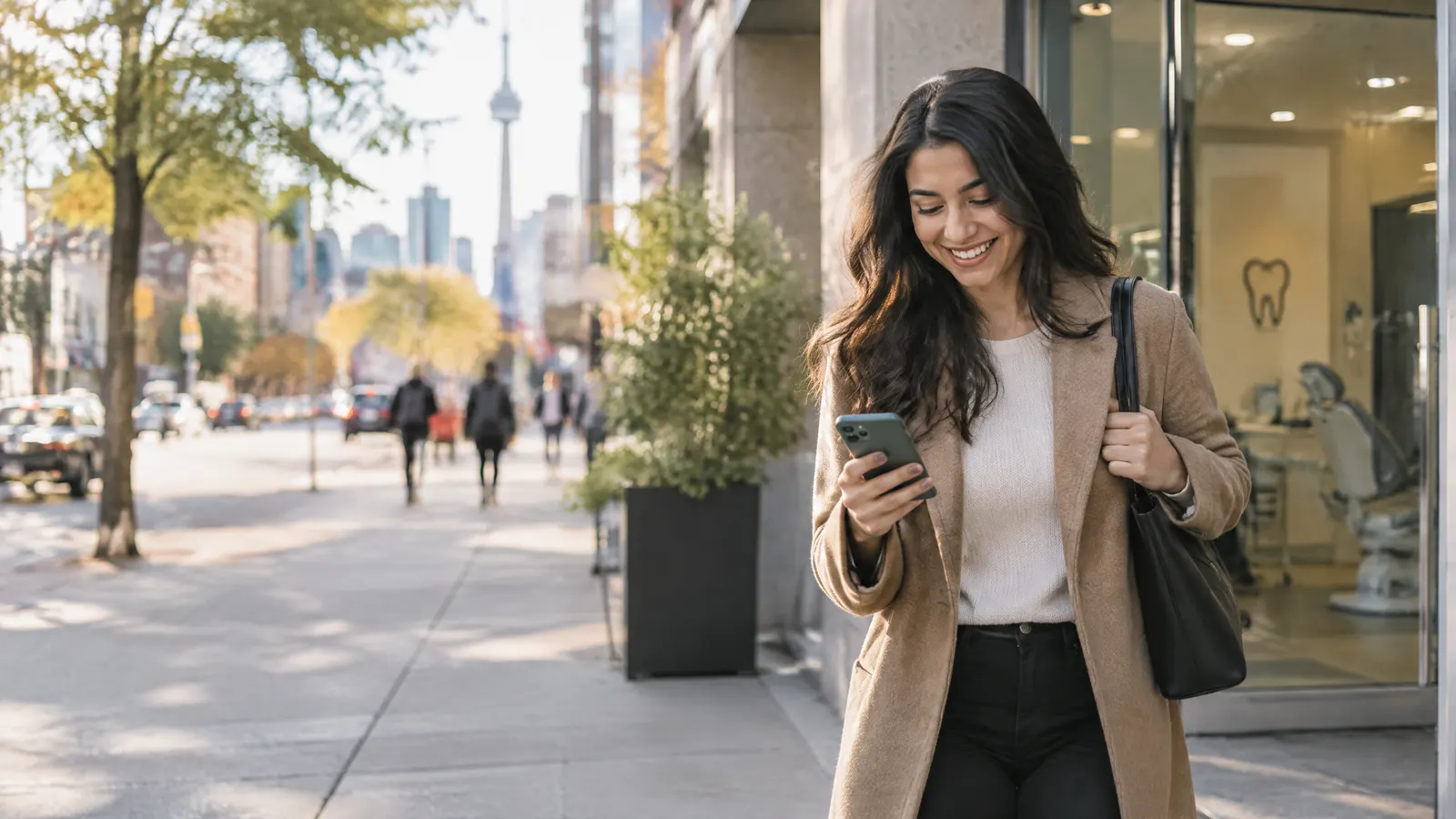 An employee leaving a dental clinic and smiling at her phone, a smooth everyday moment on a busy Ontario street.